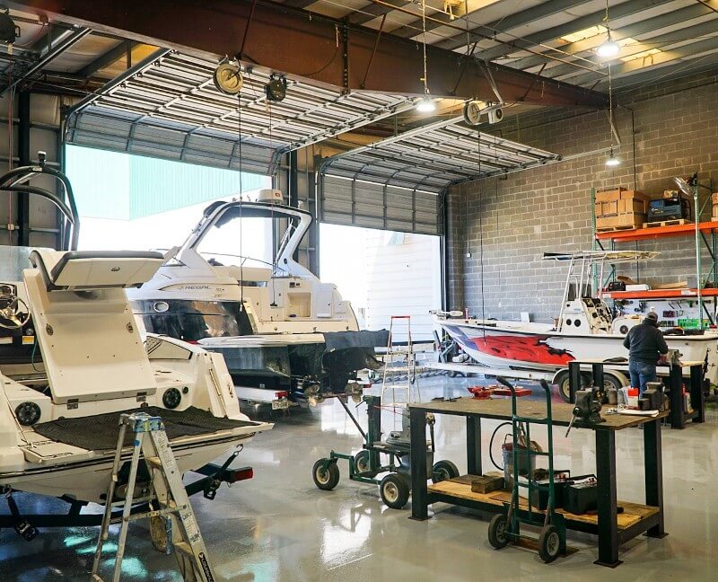 Technicians complete boat repairs inside the Marina Bay Harbor service center at Clear Lake Shores